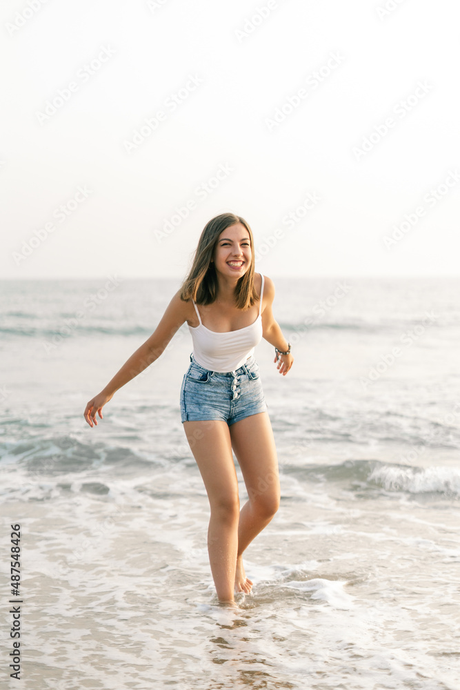 Happy woman smiling on the shore of the beach Happy woman smiling on the shore of the beach