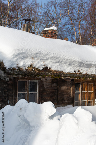 Norwegian cottage covered with snow.