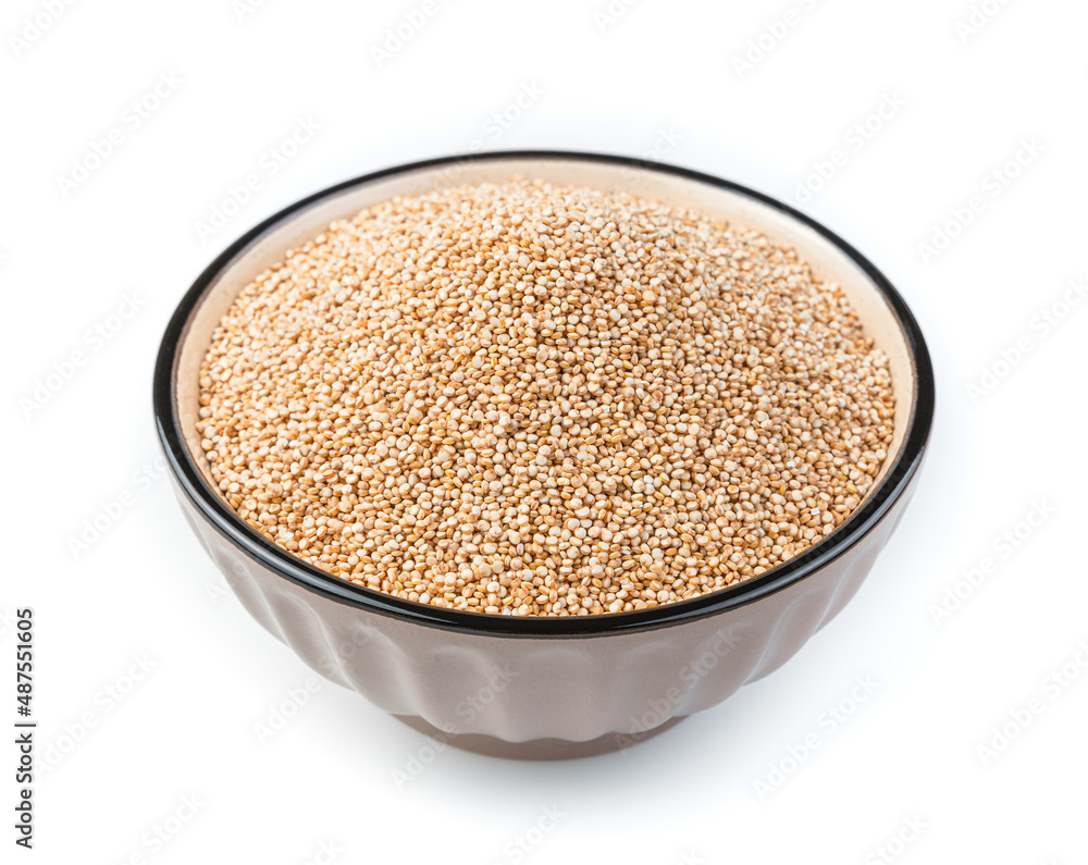 White quinoa seeds in a brown bowl are isolated on a white background in the bowl. White quinoa seeds in a brown bowl are isolated on a white background in the bowl.