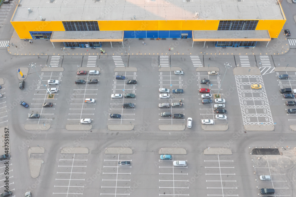 Aerial view shopping mall of goods exterior view with of parking lot space.
