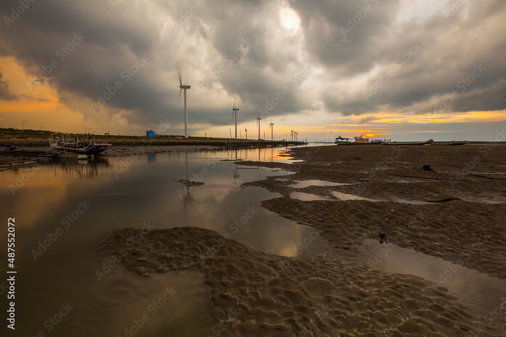 Beautiful landscape of sea level reflect fantasy dramatic sunset sky in wetlands , the famous travel attractions in Changhua Binhai Industrial Zone, Taiwan. (彰濱)