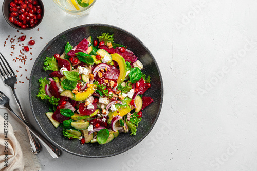 Healthy vegetable salad with beetroot, pomegranate, feta and avocado.