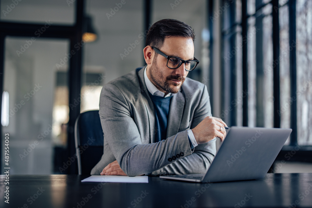 Concentrated caucasian businessman, reading his e-mails, on the laptop. Concentrated caucasian businessman, reading his e-mails, on the laptop.