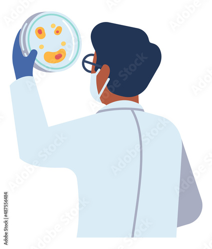 Scientist holding petri dish. Man in laboratory coat looking at bacterial colony