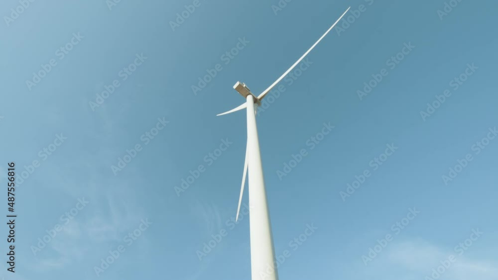 Concept of electric power production and clean energy. Large wind turbines with blades. Clean Renewable Energy. Wind turbines generating clean renewable energy. Renewable energy production. Concept of electric power production and clean energy. Large wind turbines with blades. Clean Renewable Energy. Wind turbines generating clean renewable energy. Renewable energy production.