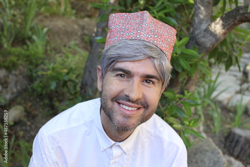 Cheerful man with traditional embroidered moroccan hat