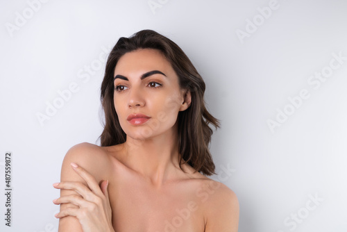 Close-up beauty portrait of a topless woman with perfect skin and natural make-up