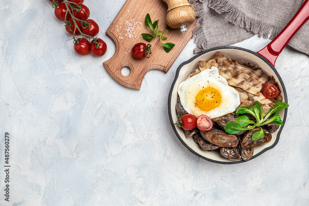 Fototapeta premium Baked sweet purple potatoes, grilled bacon and fried egg in pan and coffee on white background. Keto breakfast or lunch. Healthy fats, clean eating for weight loss, top view