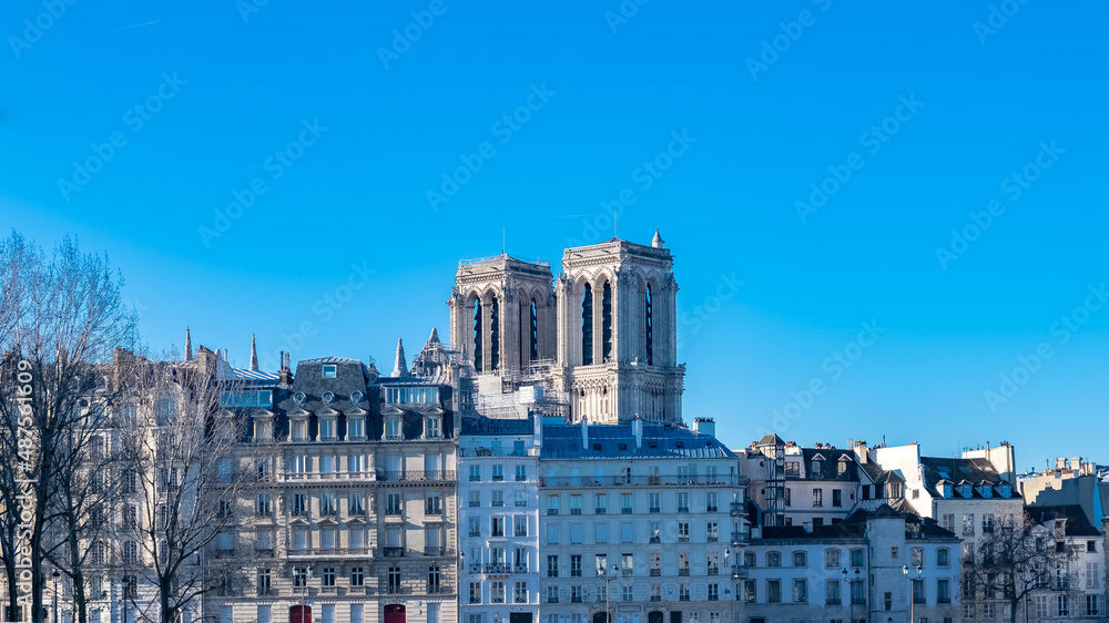 Paris, Notre-Dame cathedral under construction and typical facades on the ile de la Cite 
