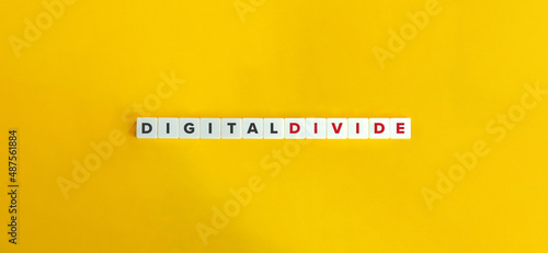 Fotografie Digital Divide Buzzword on Letter Tiles on Yellow Background