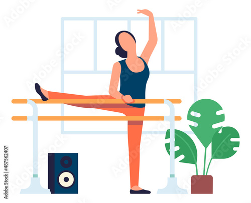 Young woman stretching on ballet barre. Dance class training
