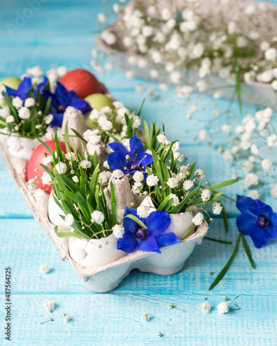 Easter. Painted eggs. Grass and flowers in a shell. Easter Still Life