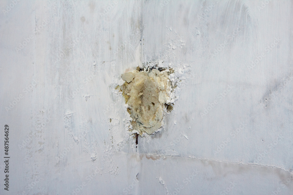 Expanding foam fills a hole in a wall the foam has been cut ready for