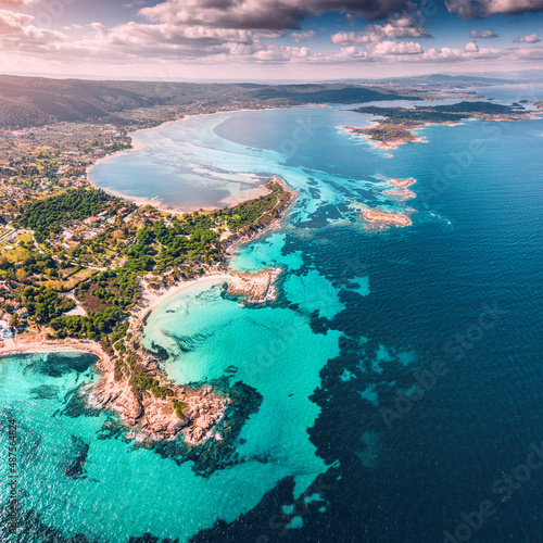 Aerial view of the paradise seashore with various shades of turquoise water. Coral reefs and secluded sandy beaches in the resort village of Vourvourou in Sithonia, Halkidiki.