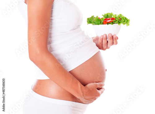 Pregnant woman eating salad