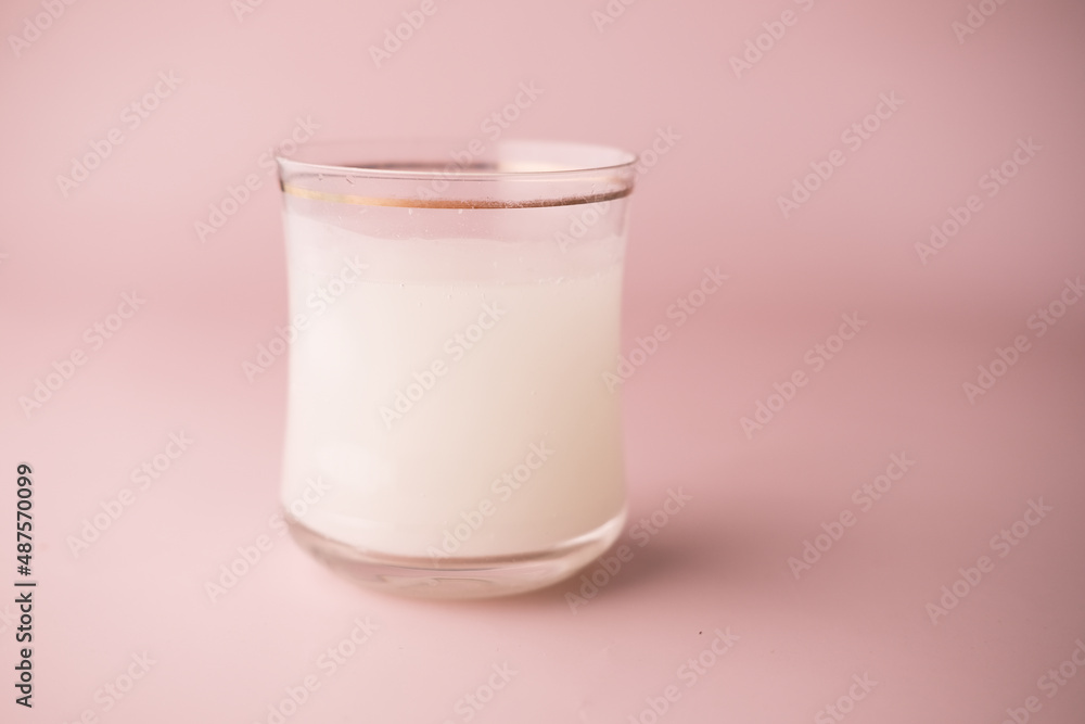 Effervescent soluble tablet pills and glass of water on purple background Effervescent soluble tablet pills and glass of water on purple background