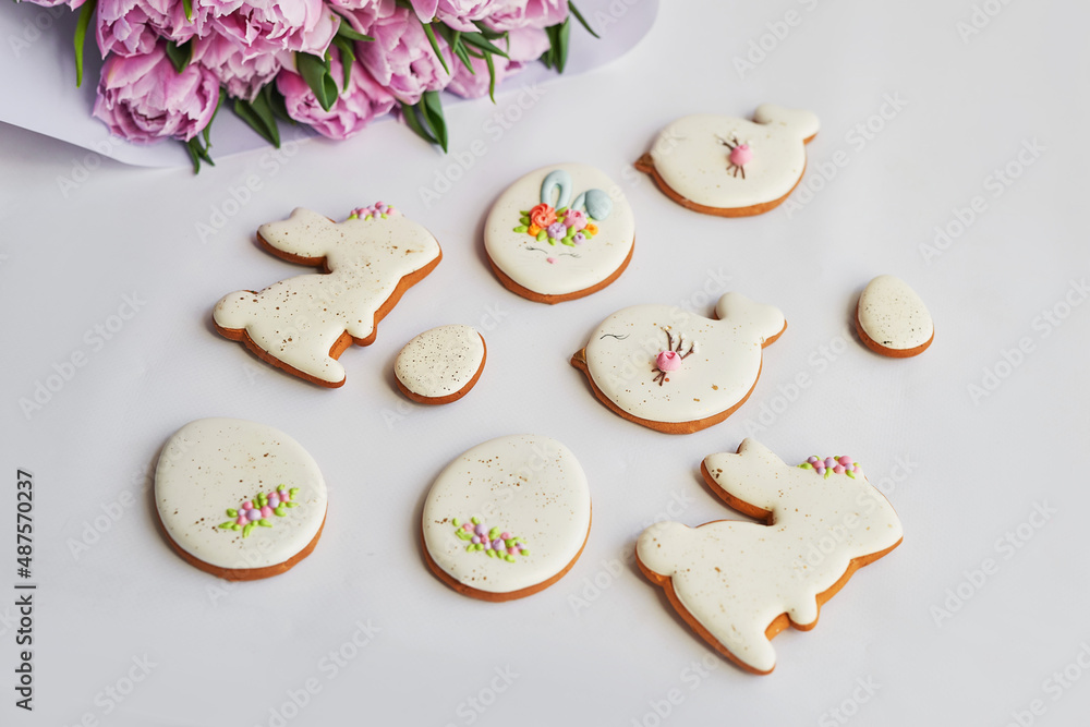 Easter composition with sweet bread, gingerbread rabbits and eggs, bouquet of flowers tulip. Holidays breakfast. Traditional easter gingerbread cookies. Easter Greeting Card Template Easter composition with sweet bread, gingerbread rabbits and eggs, bouquet of flowers tulip. Holidays breakfast. Traditional easter gingerbread cookies. Easter Greeting Card Template