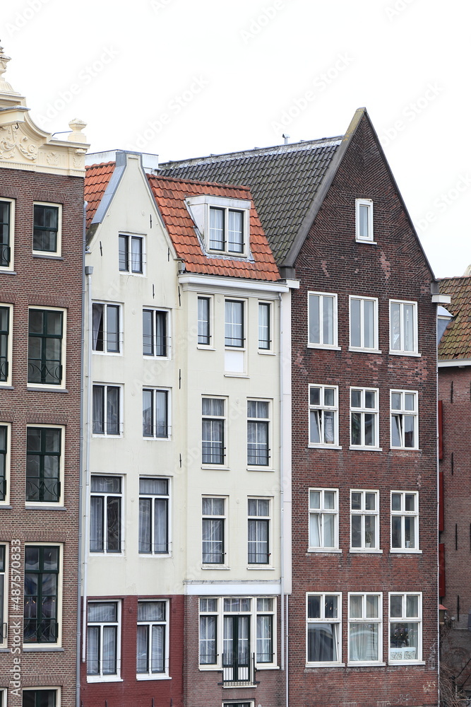 Fototapeta premium Amsterdam Damrak Canal Traditional House Facades with Spout and Pointed Gables, Netherlands
