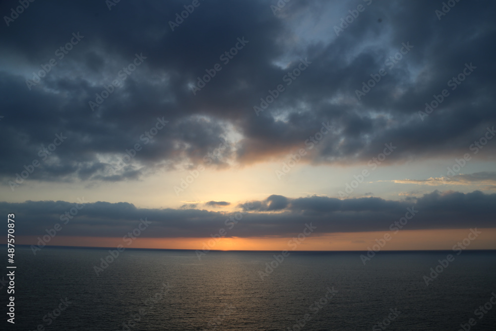 Sunset over the Mediterranean sea with clear sky. Sun over the water with cloudy atmospheric moods