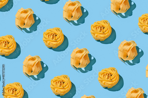 Pasta tagliatelle and pappardelle repeating seamless pattern on blue backdrop photo