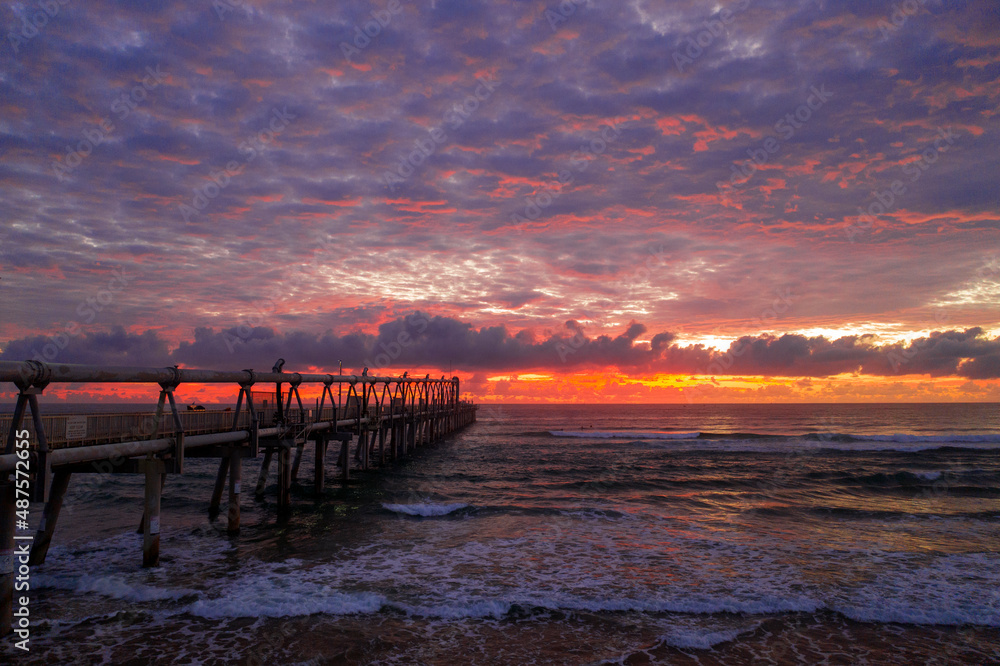 Colourful sunrise sky with jetty at Gold Coast SPIT