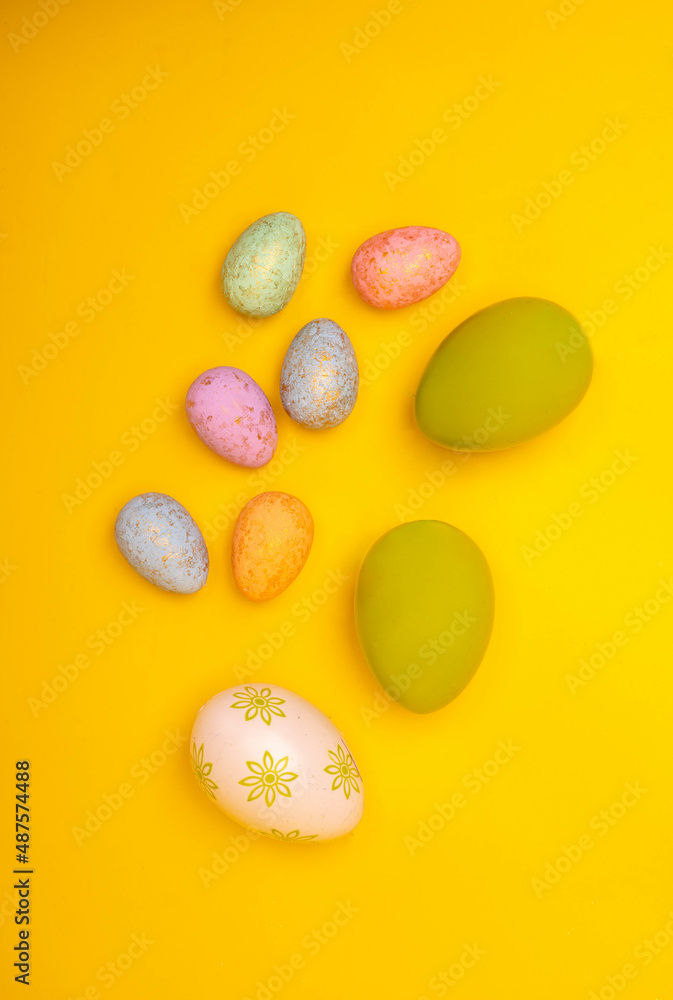 Hand painted easter eggs on a yellow background, top view. Easter decorations, postcard, photo with a copy space. Hand painted easter eggs on a yellow background, top view. Easter decorations, postcard, photo with a copy space.