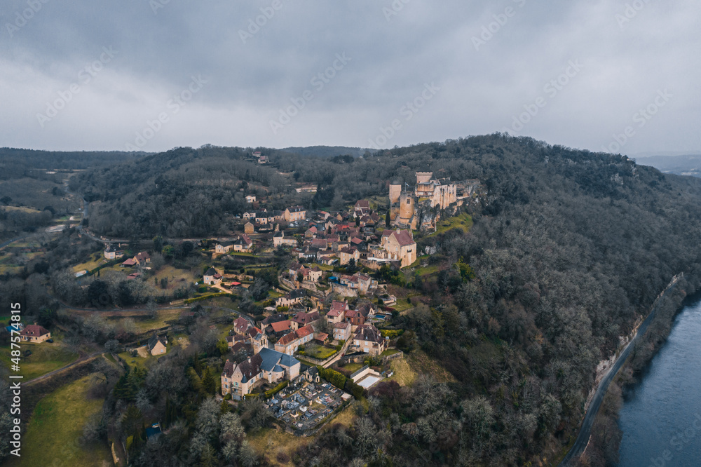 Aerial view of an ancient medieval French village and Castelnaud-la-Chapelle Castle on the mountain in France Aerial view of an ancient medieval French village and Castelnaud-la-Chapelle Castle on the mountain in France