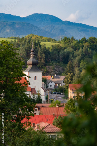 view of green countryside during summer village and church in valley