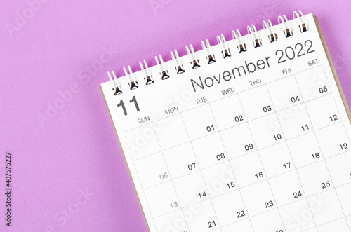 November 2022 desk calendar on light purple background.