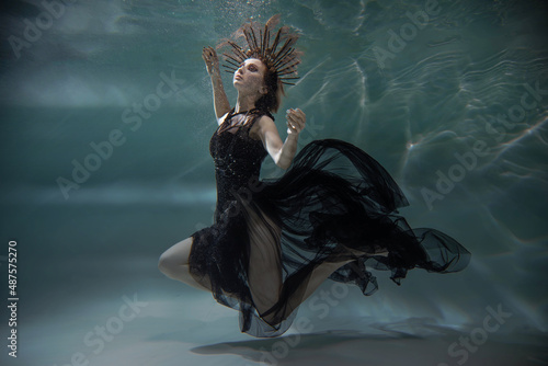 girl in black dress underwater