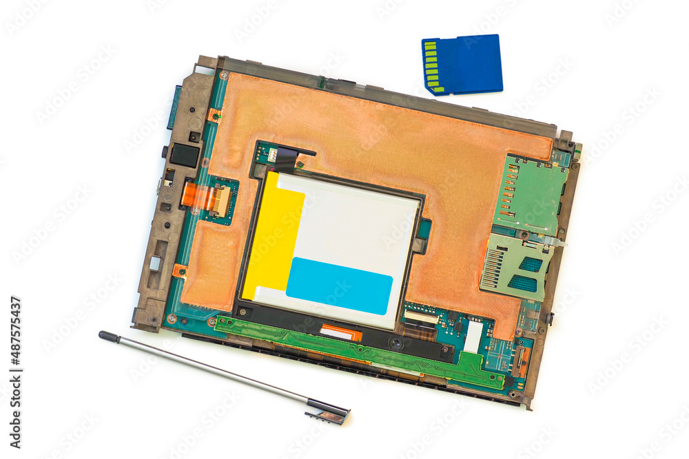 Disassembled e-book with stylus and SDXC memory card isolated on white background. Electronic book, broken equipment, top view Disassembled e-book with stylus and SDXC memory card isolated on white background. Electronic book, broken equipment, top view