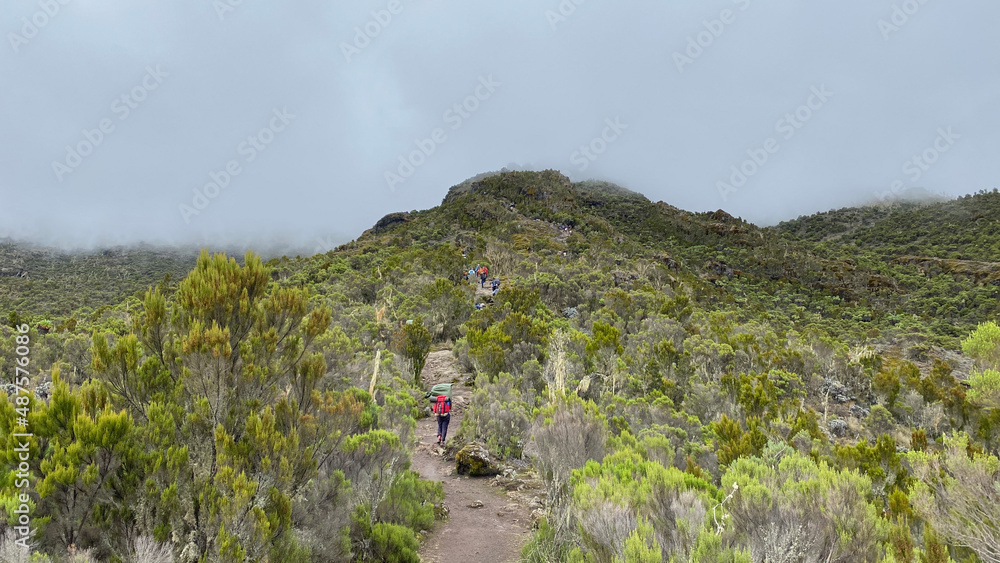 The amazing nature of Tanzania. A group of tourists goes up the mountain. Mountain landscape.