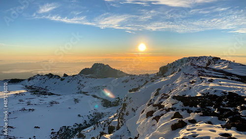 Amazing panorama from Uhuru Peak. Dawn in the mountains. Snow-covered crater of Mount Kilimanjaro.