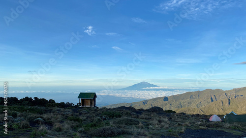 Mount Meru on the horizon. Beautiful mountain landscape. Climbing Kilimanjaro, Africa.