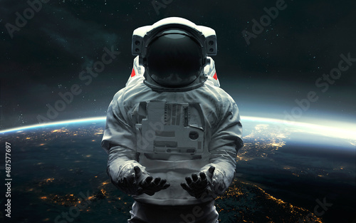 Fototapeta Naklejka Na Ścianę i Meble -  Astronaut at the Earth orbit. 5K realistic science fiction art. Elements of image provided by Nasa