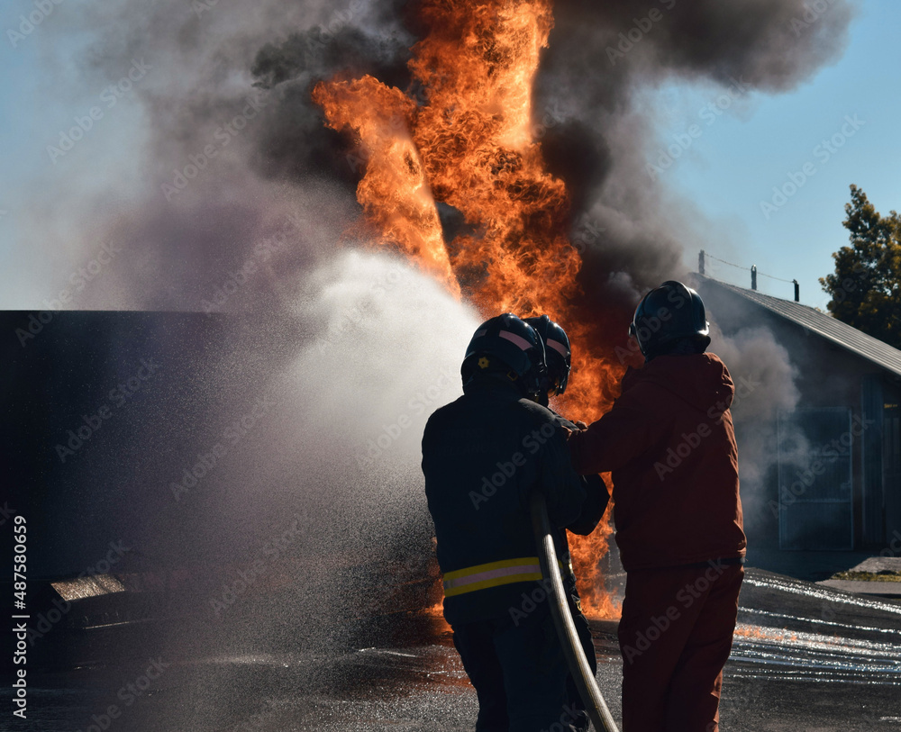 Firefighter extinguishing a traffic accident fire