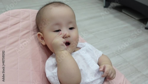 4K footage of cute baby girl sucking fingers