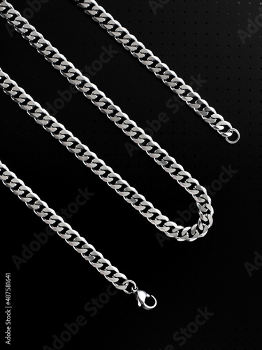 Men's silver chain on a black background with standard links