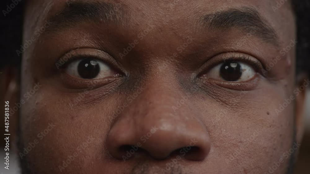 Extreme close-up of a surprised african-american man's eyes recieving good news Extreme close-up of a surprised african-american man's eyes recieving good news