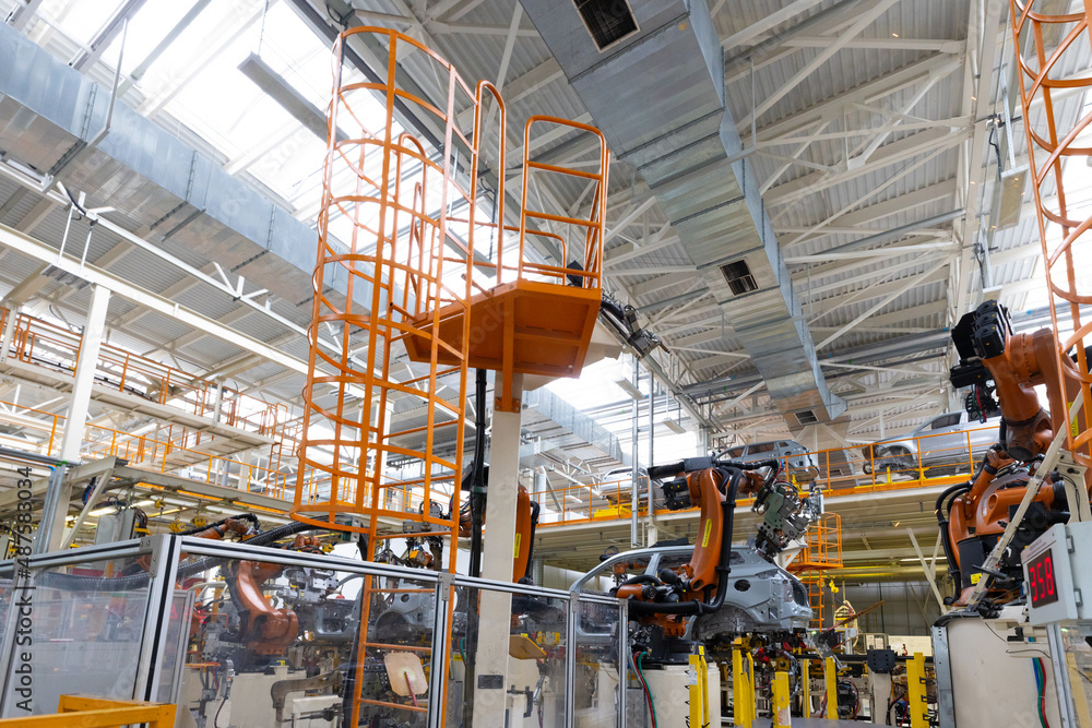 Photo of automobile production line. Welding car body. Modern car assembly plant. Auto industry. Interior of a high-tech factory, modern production Photo of automobile production line. Welding car body. Modern car assembly plant. Auto industry. Interior of a high-tech factory, modern production