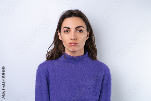 Young woman in purple soft cozy sweater in the background upset © Анастасия Каргаполов