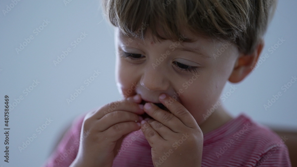 Little boy eating piece of bread child eats carb food Little boy eating piece of bread child eats carb food