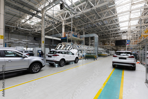 Automobile production line. Modern car assembly plant. Interior of a high-tech factory  manufacturing