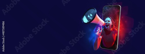 Creative art collage, Young beautiful girl shouting at megaphone from phone screen isolated on dark background. Concept of sales, ads, technology photo