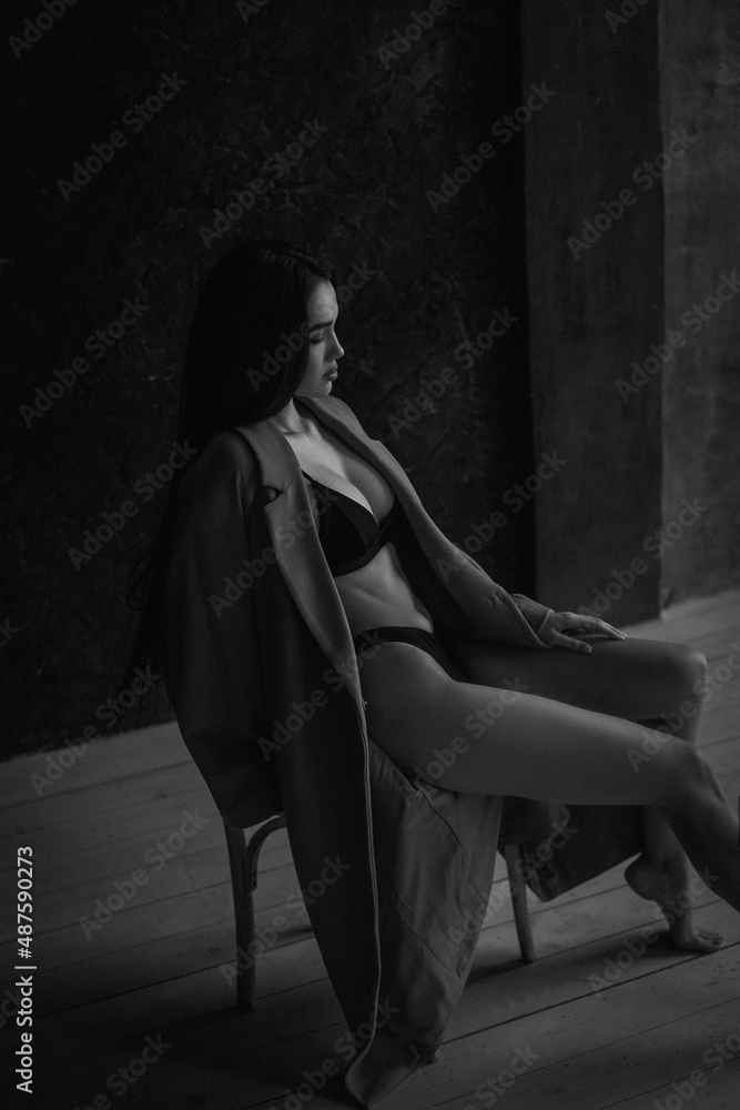 Black and white portrait of attractive young woman in lingerie and coat Black and white portrait of attractive young woman in lingerie and coat