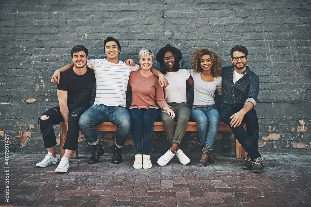 Fototapeta premium We there for each other. Shot of a diverse group of people chilling together outside.