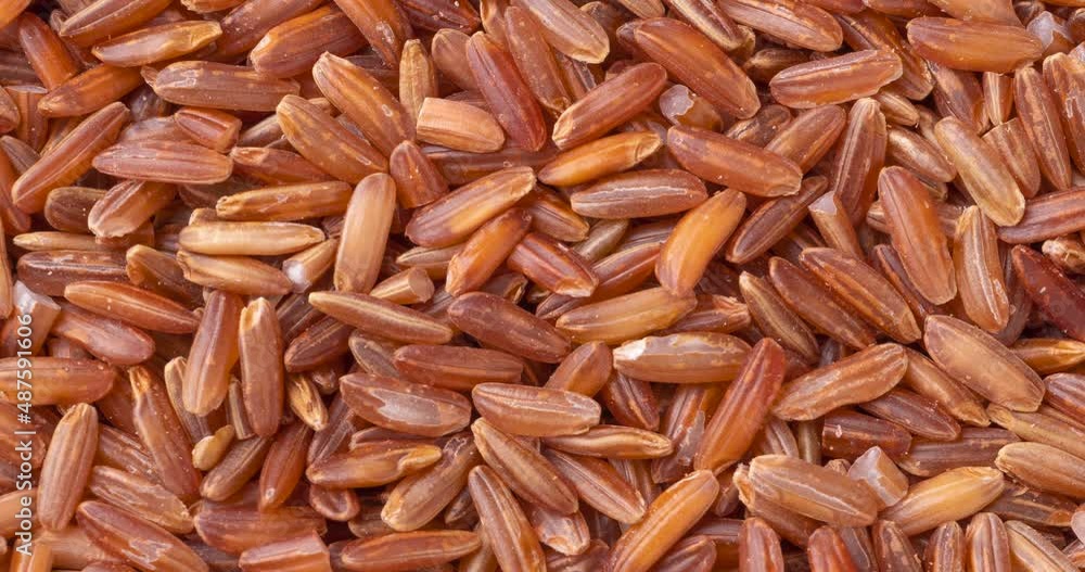 Closeup, top view of whole grain red rice. Food backdrop