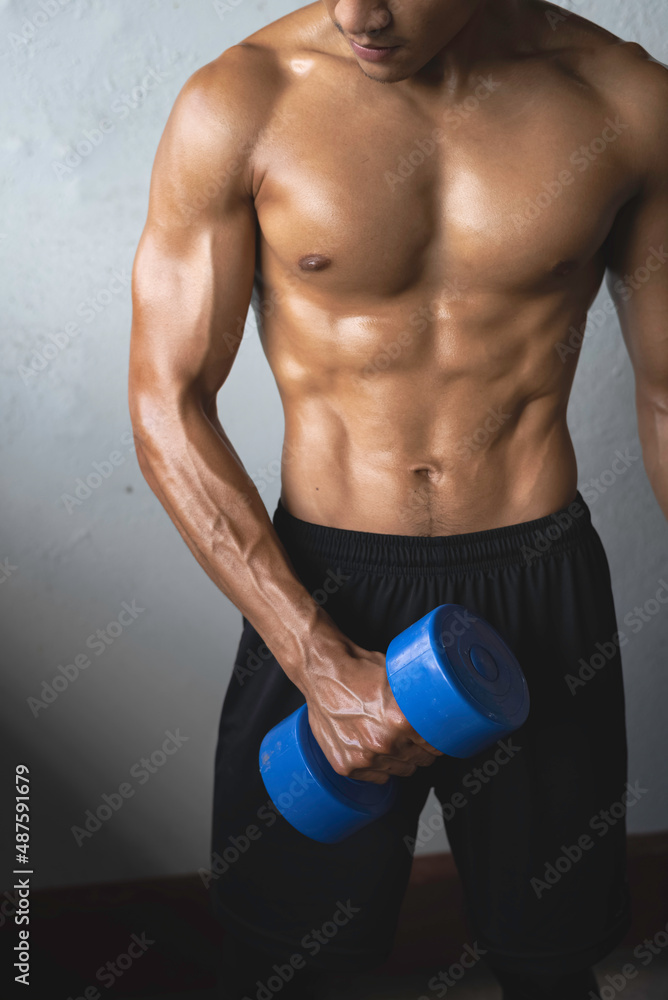 Naklejka premium Young man with fit and firm muscle