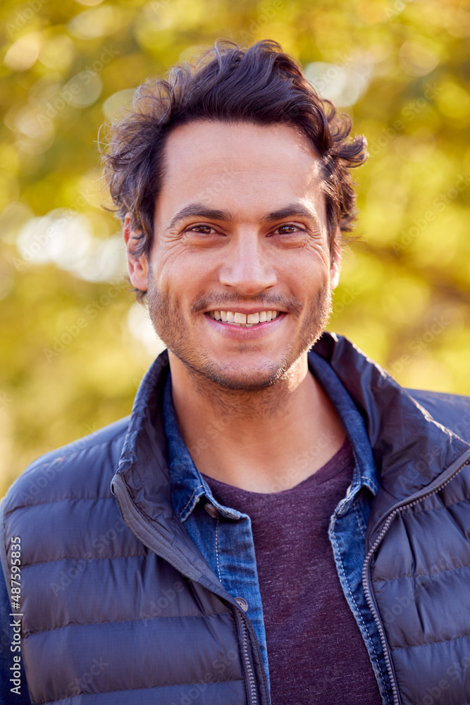 Portrait Of Smiling Man Outdoors Relaxing In Autumn Park Portrait Of Smiling Man Outdoors Relaxing In Autumn Park