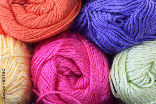 Close up of colorful yarn. Orange, purple, yellow, pink, and green yarn